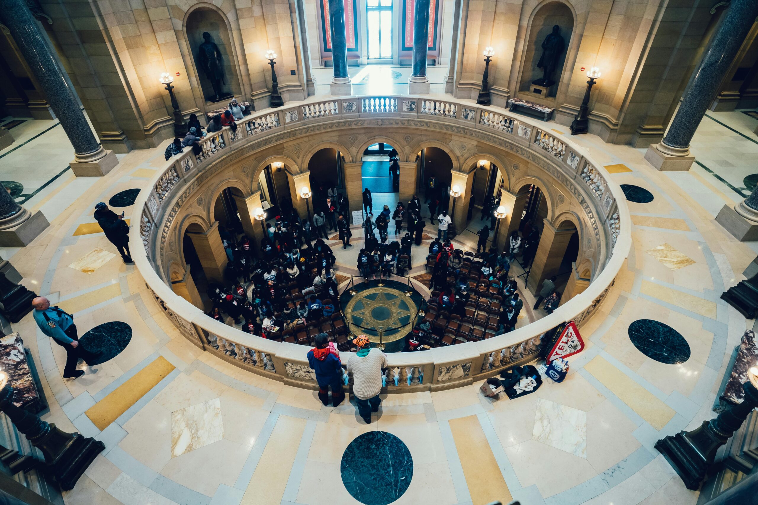 Interior view of a grand architectural rotunda with a gathering, highlighting luxurious design and modern elegance.